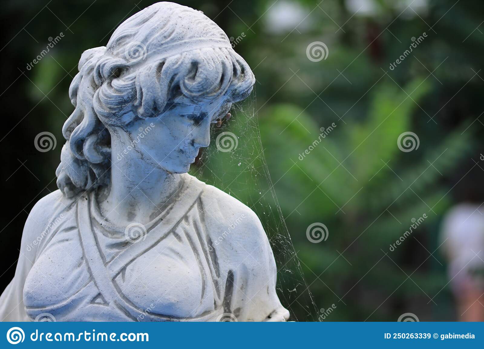 Old statue abandoned in a garden